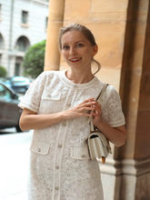 A woman wears a modest mini dress